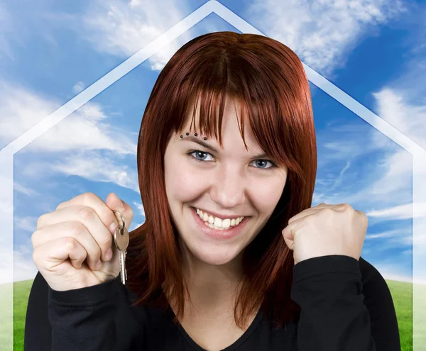 Successful girl smiling holding keys with a hous — Stock Photo, Image