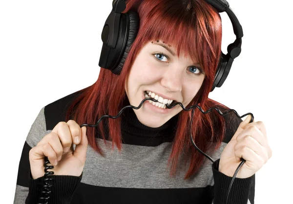 Girl biting headphone cable — Stock Photo, Image