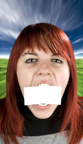Girl biting a blank greeting card — Stock Photo, Image