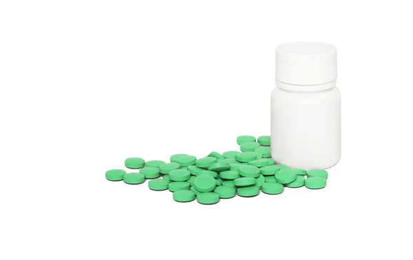 Green pills and a white container — Stock Photo, Image