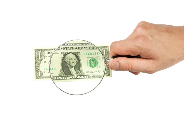 Dollar bill and hand holding magnifying glass — Stock Photo, Image