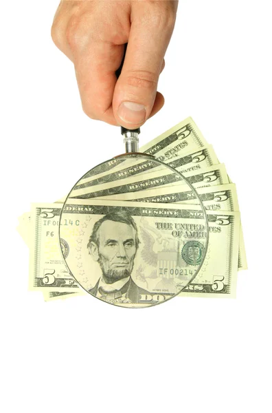 Dollarbiljetten en hand met Vergrootglas — Stockfoto