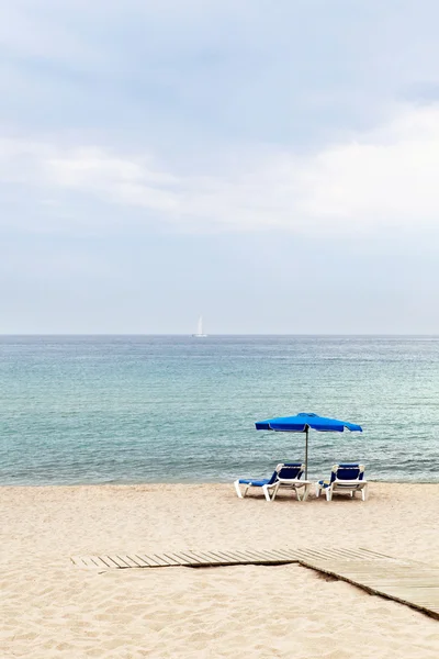 stock image Two lounges and umbrella