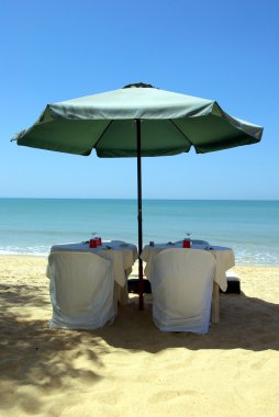 Restaurant on the beach with umbrella clipart