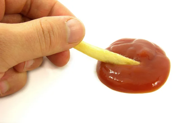 Chip in ketchup with hands — Stock Photo, Image