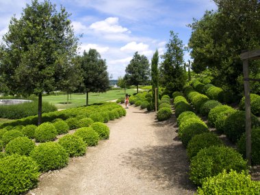 Girl walking through the Amboise garden clipart