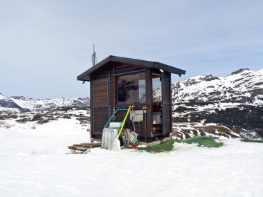 Remote Cabin in snowy mountain clipart