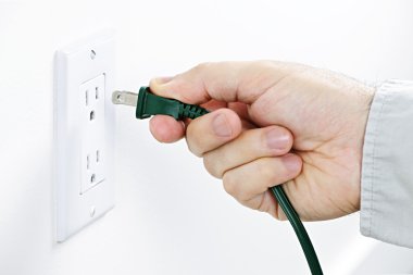 Hand inserting plug into outlet clipart