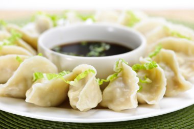 Steamed dumplings and soy sauce clipart