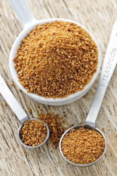 Coconut palm sugar in measuring spoons — Stock Photo, Image