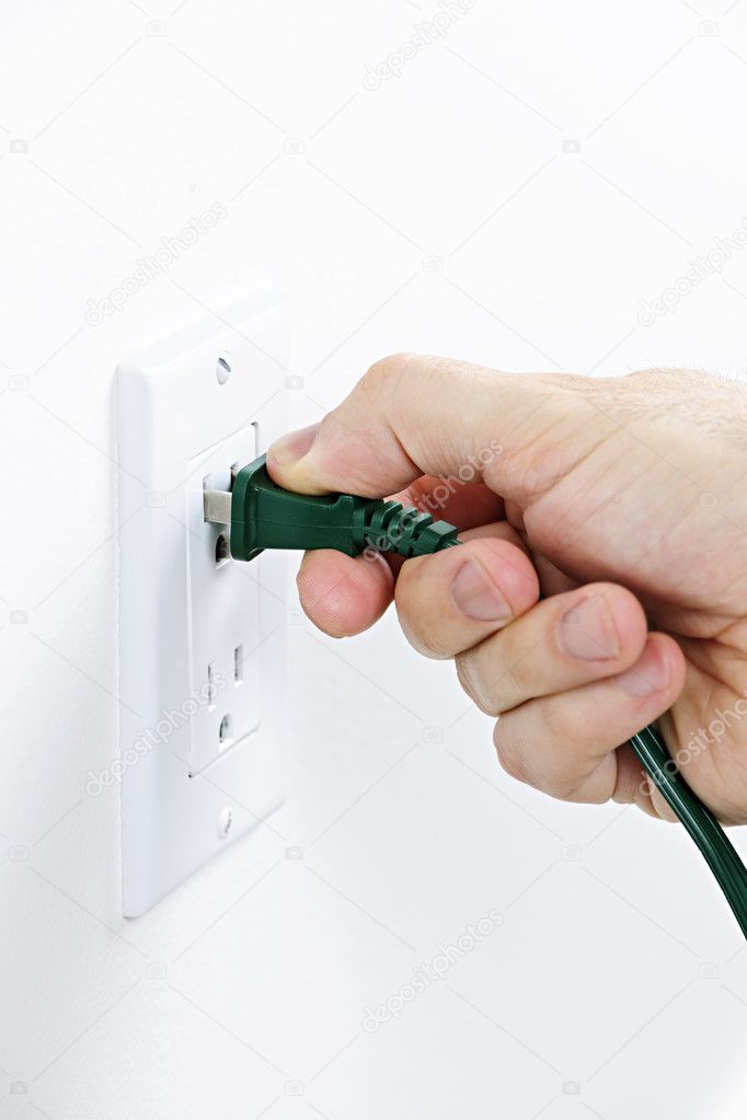 Hand inserting plug into outlet — Stock Photo © elenathewise #4466210