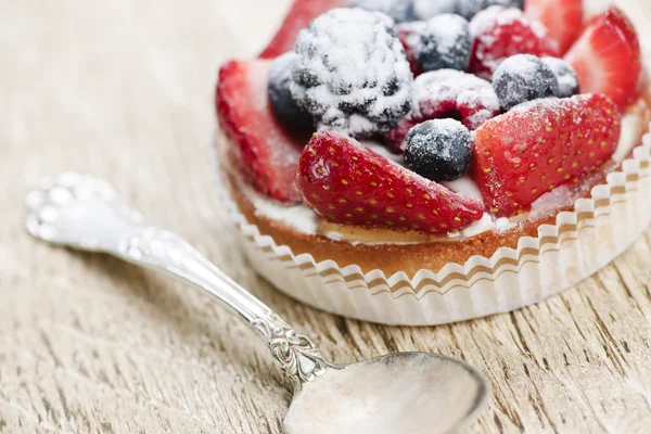 Fruit tart with spoon — Stock Photo, Image
