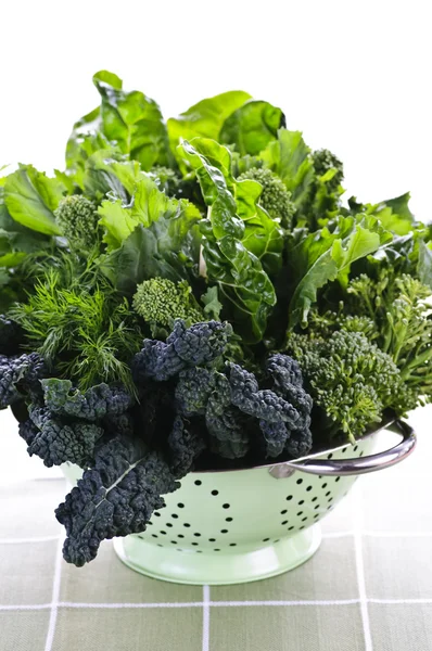 Dark green leafy vegetables in colander — Stock Photo, Image
