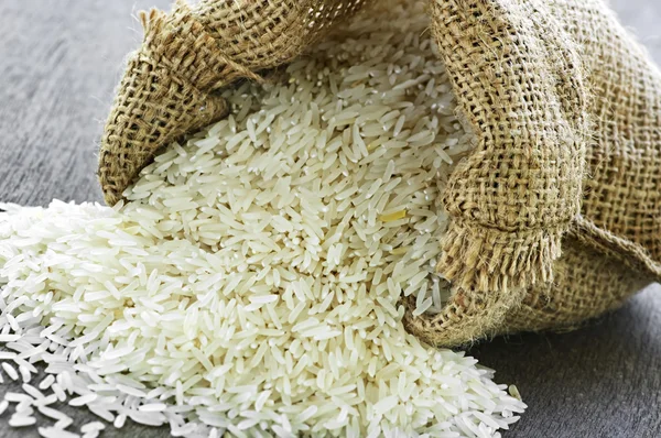 Long grain rice in burlap sack Royalty Free Stock Photos