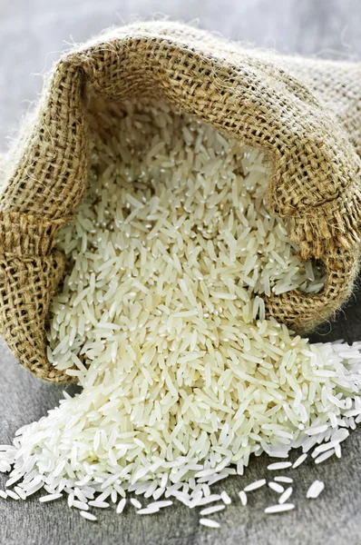 Long grain rice in burlap sack Stock Photo