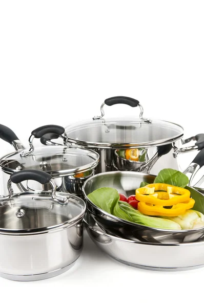 Stainless steel pots and pans with vegetables — Stock Photo, Image