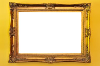 Empty gold picture frame on yellow wall clipart