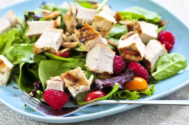 Healthy green salad with grilled chicken breast clipart