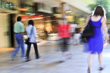 shopping in a mall, panning shot, intentional in-camera motion blur clipart