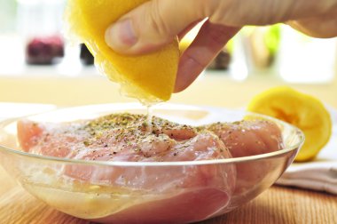 Raw chicken breasts marinating clipart