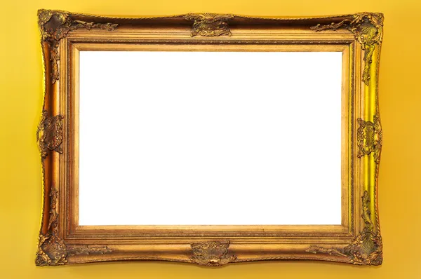 stock image Empty gold picture frame on yellow wall