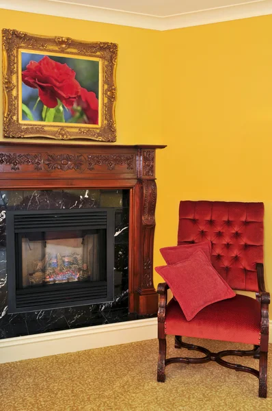 Fireplace and red chair — Stock Photo, Image