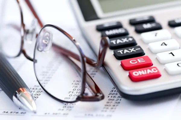 Tax calculator pen and glasses Stock Image