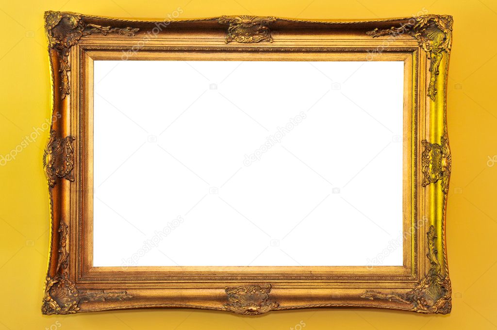 Empty gold picture frame on yellow wall