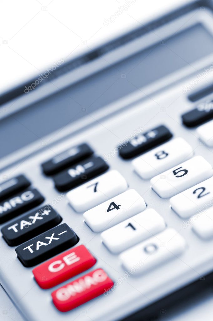 Closeup on tax calculator keypad with red black and white buttons