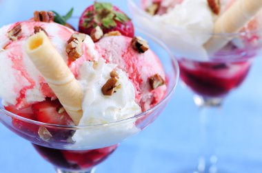 Strawberry ice cream sundae with fresh strawberries and walnuts clipart