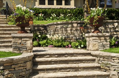 Natural stone landscaping in front of a house clipart