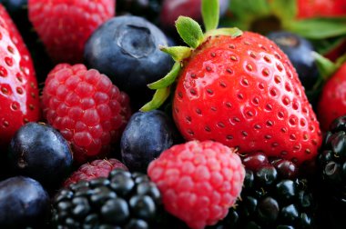 Background of assorted fresh berries close up clipart