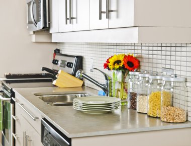 Modern small kitchen interior with natural stone countertop clipart