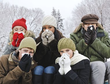 Group of friends with colds outside in winter clipart