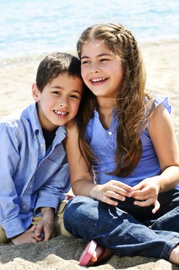 Brother and sister at beach clipart