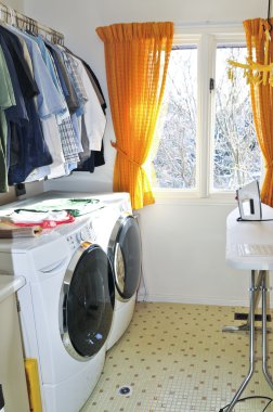Laundry room with modern washer and dryer clipart