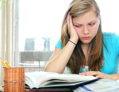 Teenage girl studying with textbooks clipart