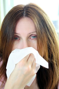 Mature woman with a flu or an allergy symptoms clipart