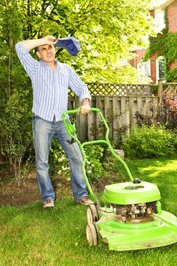 Man taking a break while mowing lawn on hot summer day clipart