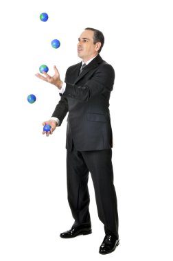 Business man in suit juggling planet earth balls clipart