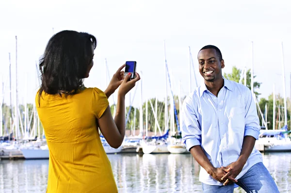 Man posing for picture near boats — Stock Photo, Image