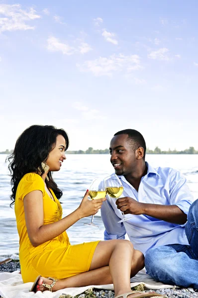 Casal feliz tendo vinho na praia — Fotografia de Stock
