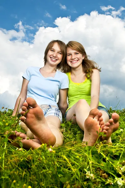 Zwei Junge Freundinnen Teenageralter Sitzen Barfuß Auf Der Sommerwiese — Stockfoto