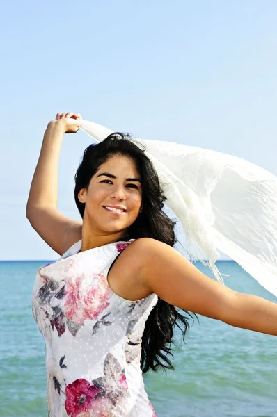 Mooie jonge vrouw op strand met witte sjaal — Stockfoto