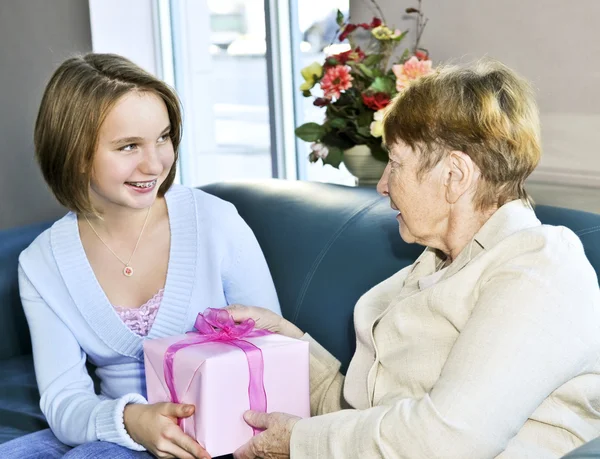 Granddaughter Giving Present Her Grandmother — Stok fotoğraf