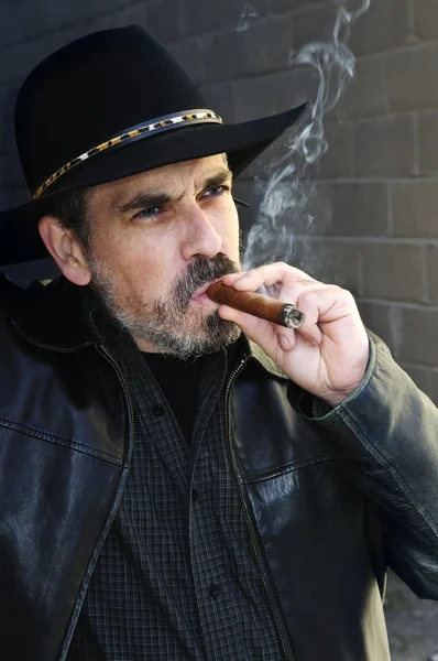 Бородатый мужчина курит сигару — стоковое фото