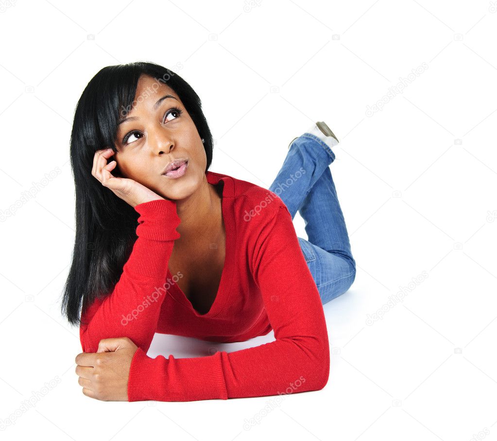 Portrait of black woman looking up and laying on white background