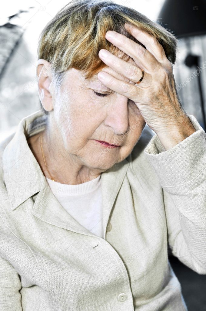 Elderly woman holding head
