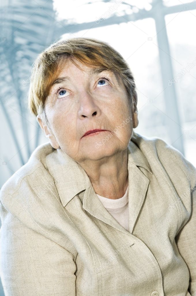 Senior woman looking up with abstract background