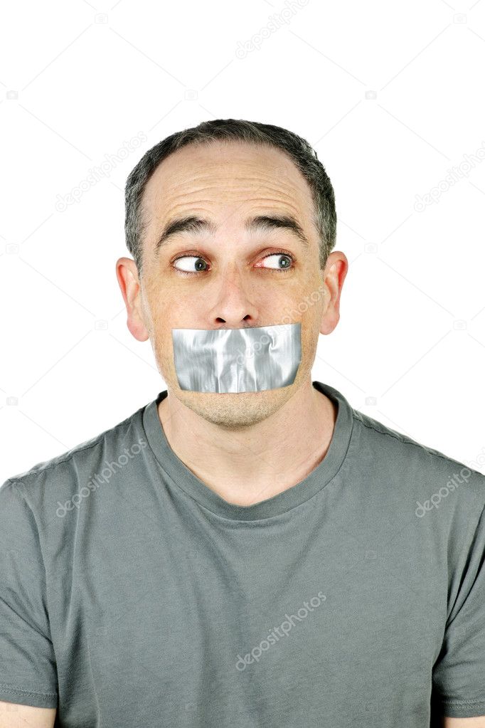 Portrait of man with duct tape over his mouth glancing sideways